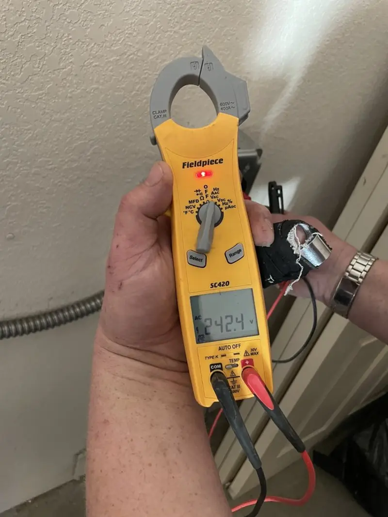 Voltage testing with clamp meter during Recessed Lighting Installation in Hazelwood